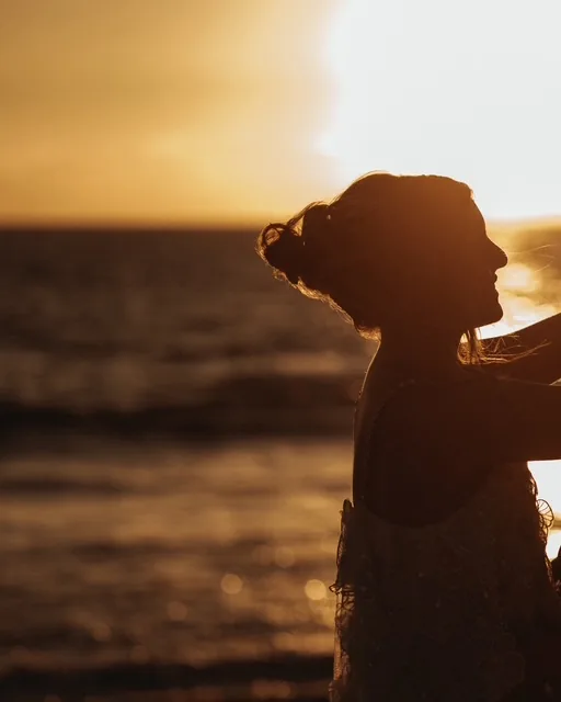 A figure backlit against the setting sun